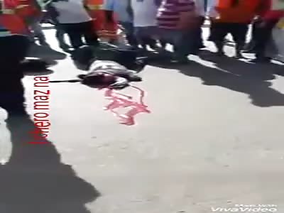 dead woman lying on the asphalt