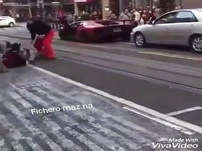 WTF: man passes by sports car and is hit by owner who hits him