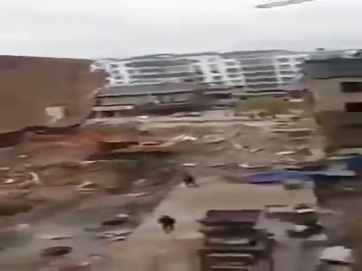 building falls on excavator
