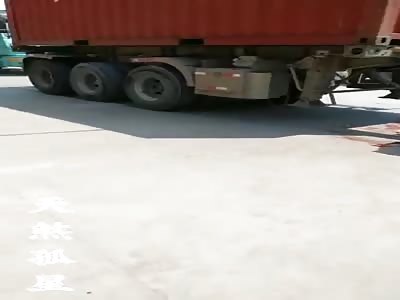 man under the truck tires