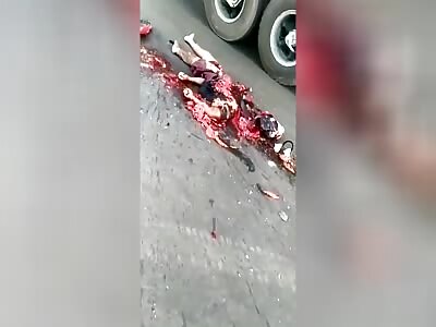 The motorcyclist fell under the truck after hitting the car