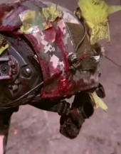 UA soldier shows a bloody Ukrainian helmet
