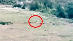 Artillery shell hits a Russian soldier while he's digging something