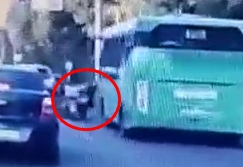 In Alma Ata, a bus fatally crushes a motorcyclist