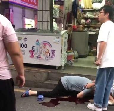 Chinese man stabbed and laying in street 