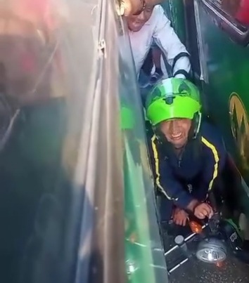 Motorcyclist trapped between two bus