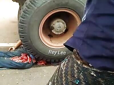 Horrifying accident and a mangled body after it was crushed by a truck