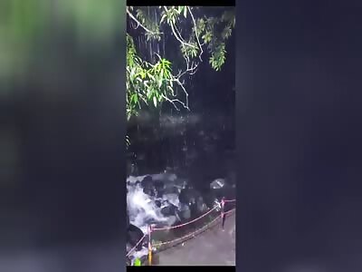 Several people are swept away by a river flood.