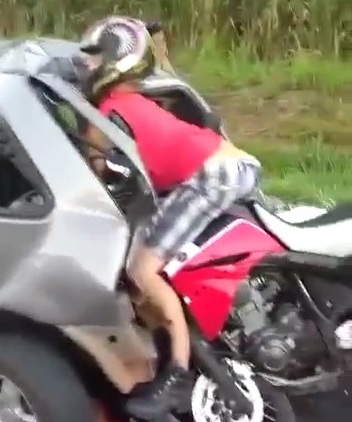Motorcyclist horrifically crashed dead and stuck in back of car