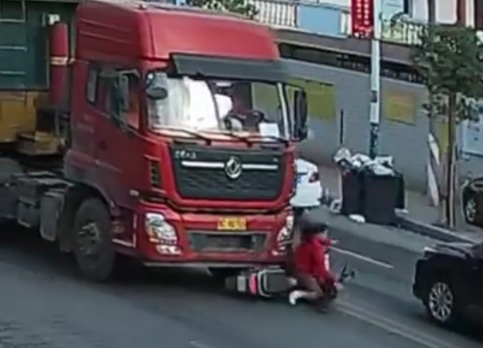 Chinese stupid girl on moped nearly crashed under big truck 