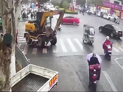 Woman sitting on scooter gets fatally run over by excavator.