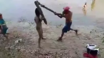 Man Smacks Woman with a Log and then Throws her into the River