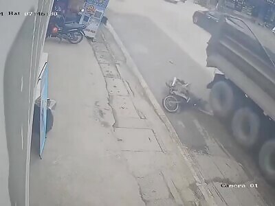 Biker's brain removed by the wheels of a truck