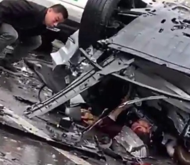 Chinese driver trapped under crashed car