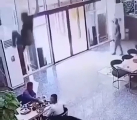 Chinese man enjoying his dinner and suddenly someone fell from the sky
