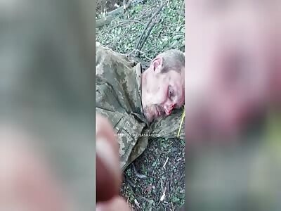 Russian special forces provide assistance to a wounded Ukrainian