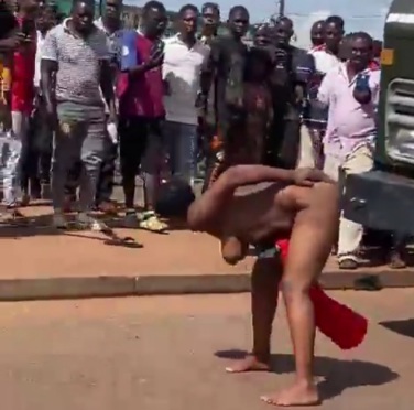 lady in Uganda stripped naked in middle of road for unclear reason 