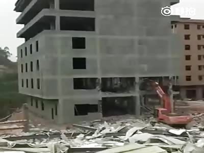 Excavator and Driver Buried by Collapsing Building
