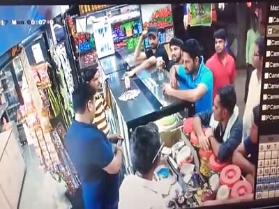 store owner takes a bottle to the face