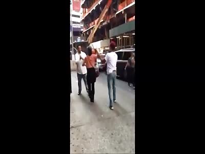 Girl tries to help her man being beating with a stick 