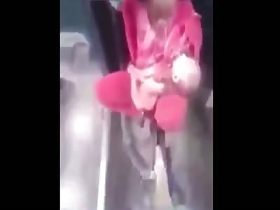 WOMAN WITH BABY IN HANDS TRAVEL BY SITTING ON COUPLER IN INDIA