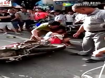 Woman gets skirt caught in motorbike wheel