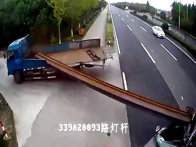 Car runs into overhanging truck