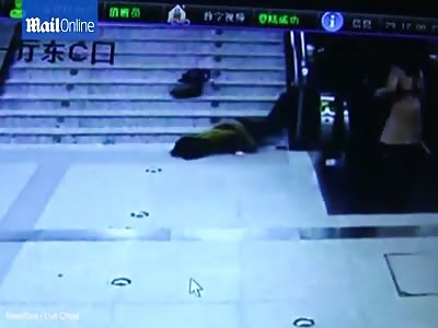 Woman falls down stairs very rapidly while looking at phone