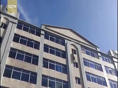 Firemen save drunk man from jumping off building in China