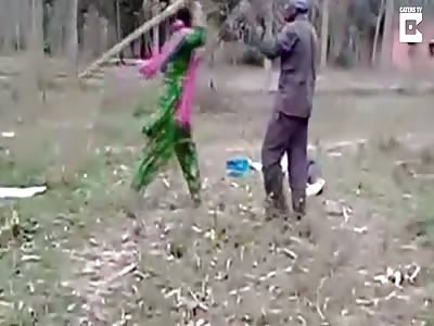 Brave woman brandishing sticks fights off five men who were mercilessly thrashing her husband 