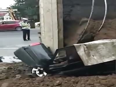 Truck loaded with sand overturned crushing car occupants