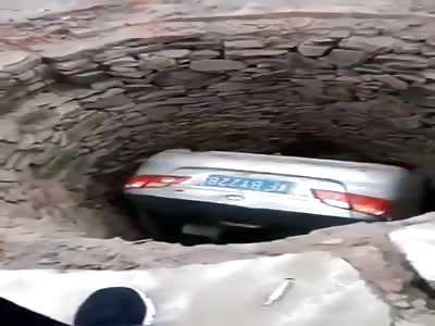 Chinese women driver stuck in here car in bottom of well