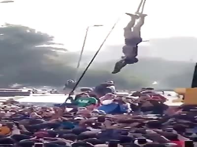 A Lynched And Dying Man Is Hung Upside Down As People Are Cheering