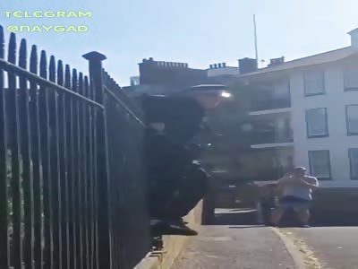 Stupid uk police trapped in fence and no one try to help him 