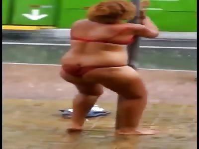 Drugged woman dancing in her underwear in the rain.