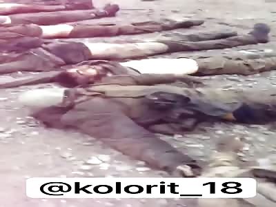 Azerbaijani soldiers showing dead bodies of Armenians enemies 