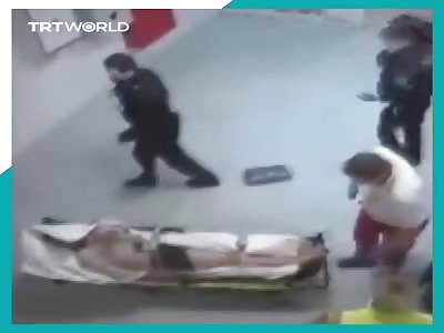  German paramedic is seen punching a Syrian refugee on a stretcher