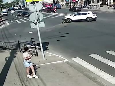 Stupid motorcyclist crashes at intersection.