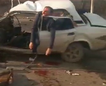 corpses lay on the road and hung in a mangled car