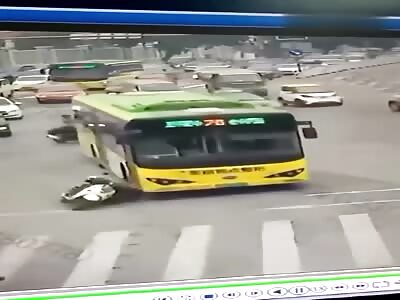 Girl on moped crushed to death under a bus.