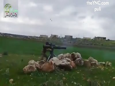 Rebels blowing up Assad truck cannon and crew with TOW in Hama Province.