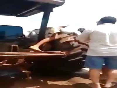 WTF. MAN TRAPPED BY THE TRACTOR WHEEL