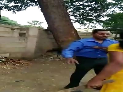 Woman punishes her husband with a stick