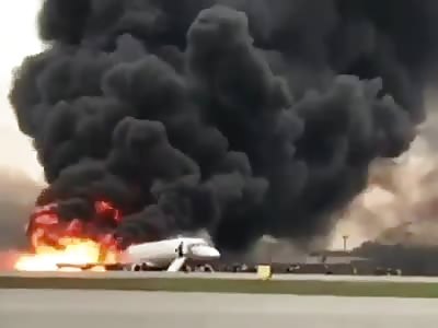 Passengers jump from the plane that caught fire at a Moscow airport