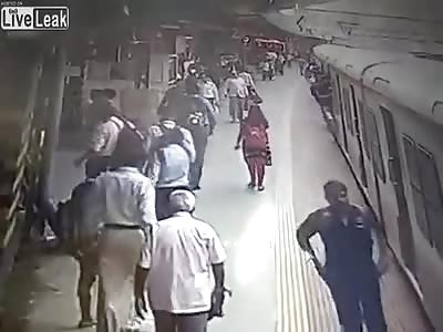 Woman slips under moving train 