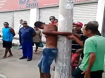 Thief trapped on pole and assaulted