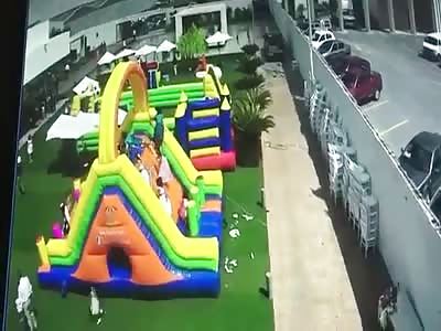  Strong wind blows inflatable game with children on top, one reports very serious