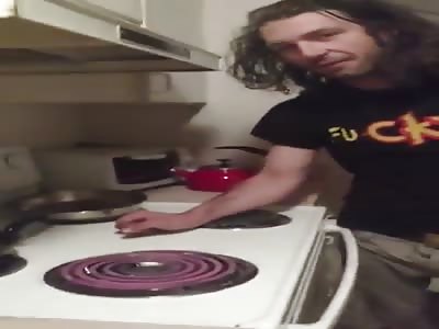 Man puts his hand on hot stove