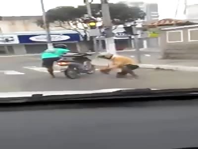 two drunks trying to get on their motorbike