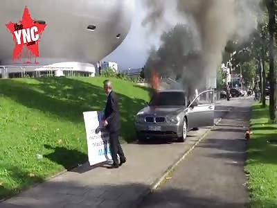 in Germany a mad man  ignites his own BMW - in protest for allegedly bad customer service.